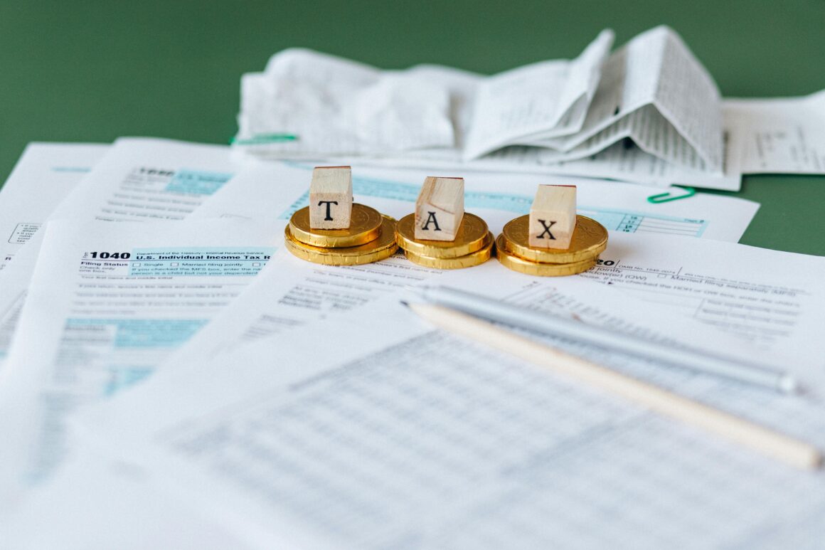 Photo of tax forms with gold coins