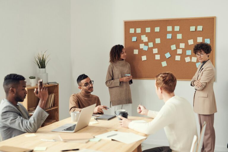 Group of people collaborating in a board room.