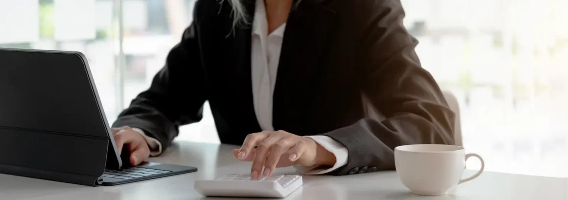 Business owner reviewing financials with a calculator
